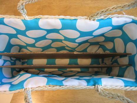 The inside of a wicker bag with blue and white polka dot patterning.