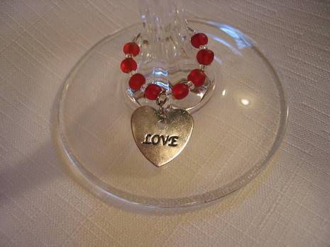 The bottom of a wineglass having an ornament with love written over it.