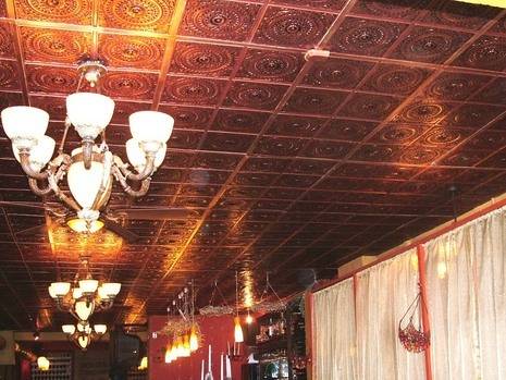 Silver tiles covering the ceiling of a roof.