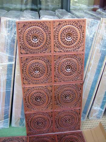Several red tiles with intricate designs stand up vertically.