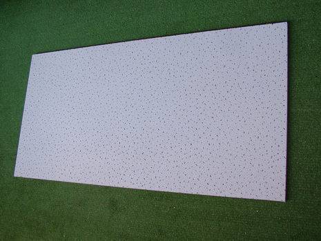 A large white panel sitting on a green surface.