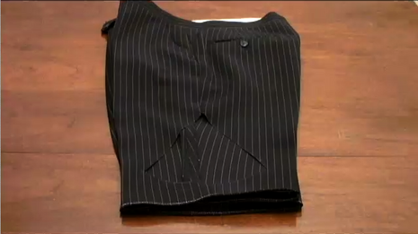 Legs are cut to a black striped pant.