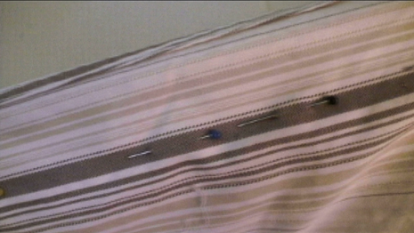 The edge of a striped tablecloth or sheet.