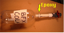A pipe is shown going into a bottle.