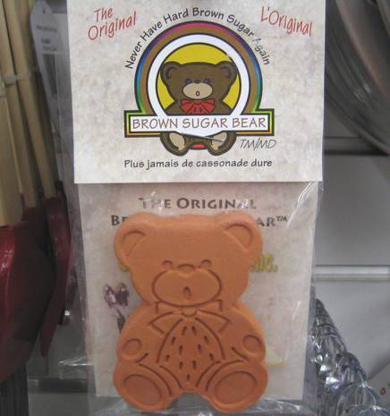 A sugar cookie in the shape of a teddy bear still in its packaging.