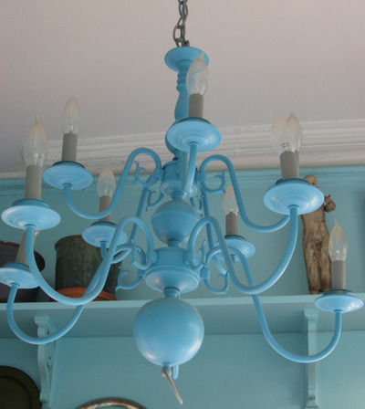 Blue chandelier in a room with matching colored walls and white ceiling.