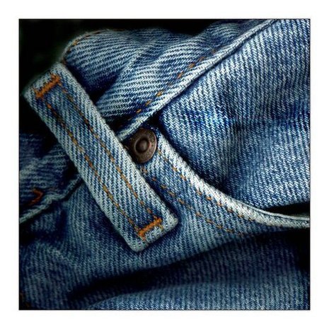 A sky blue color old jeans pant has a button on it