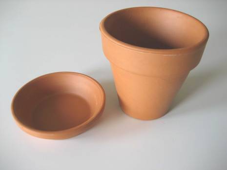 A terra cotta pot and drainage dish.