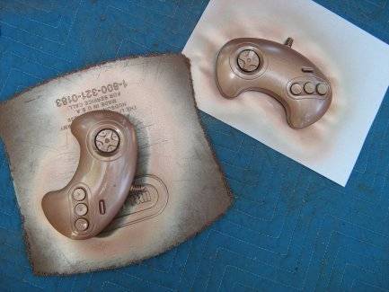 Two piece of papers having gamepad printed on them.