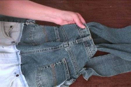 Two pairs of blue jeans hemmed together to make overalls.