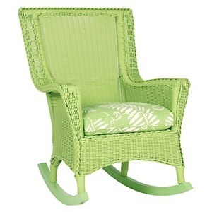 A cushioned wicker rocking chair that has been painted green
