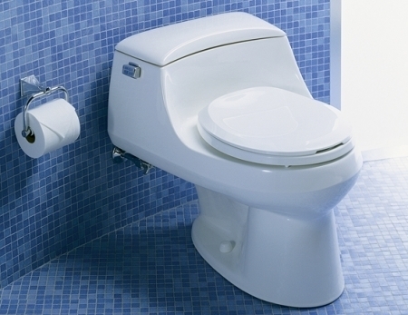 White color backline ceramic floor mounted western toilet commode with tissue roller aside in blue color bathroom.