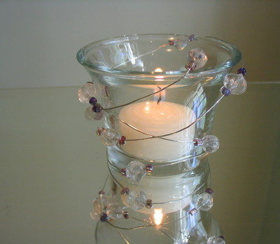 The glass candle holder which shines using the beaded wire.