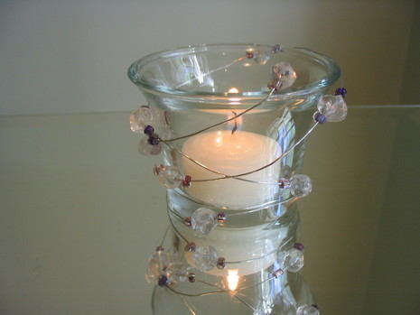The glass candle holder which shines using the beaded wire.