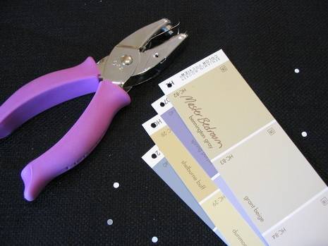 Hole punch machine punches the color catalog papers.