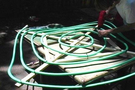 The water hose was arranged in a circular way using the wooden sticks to make it stiff to splash artificial rain.