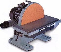 A disc sander with a red colored sanding surface.