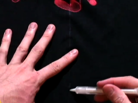 A man is showing how to make a vest out of a T-shirt.