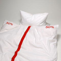 White bedding set with pillow partitioned half and half with red marking.
