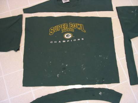 Old green sweatshirt is cut into pieces.