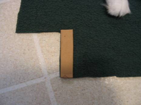 Dark cloth on the floor, measured with a piece of wood.