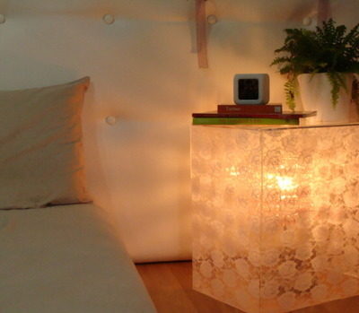 "A  bright room with acrylic bedside table lamp"