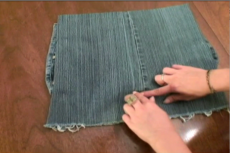A person diddling with a pair if jeans.