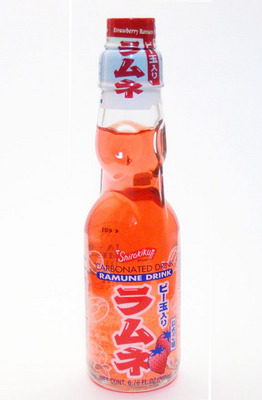 A drink with orange liquid in a clear glass bottle with Japanese type.