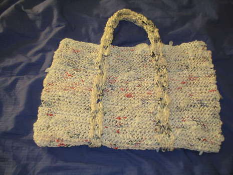 A woven handbag with a pair of handles.