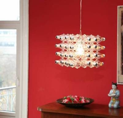 A chandlier made of lightbulbs hanging in a red room.