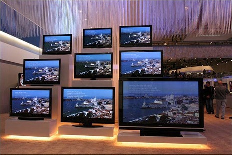 "Different Sized Flat Screen Television in a Showroom"