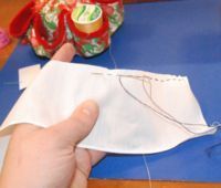 Tie a knot and sew 1/4 inch running stitches along the edge.