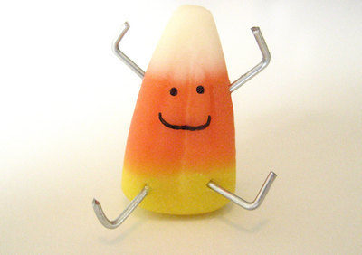 Candy corn creature with hands and legs.
