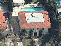 A house with a square roof and a swimming pool.