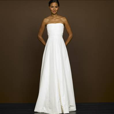 ''A women wearing a white colour wedding gown".