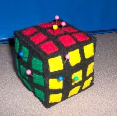A soft model of Rubik's cube with pins poked on it.