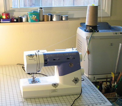 A blue and white sewing machine on a table.
