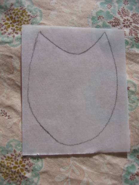 A pattern has been drawn on a piece of fabric to show where to cut or sew to make something.