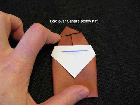 Man folding paper to make Santa.