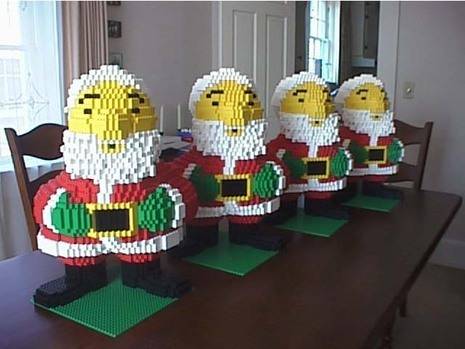 Four Lego Santas on a table.