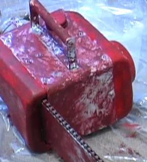 An old, red chainsaw.