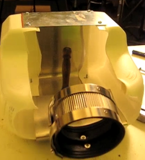 A metal round piece is near its base.