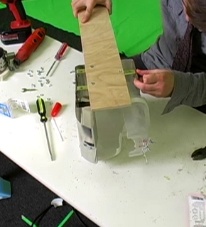 Man using tape to seal up a tool.