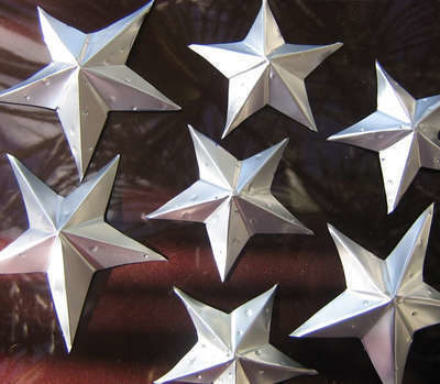 Several silver metallic stars are next to each other.
