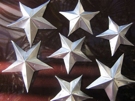 Several silver metallic stars are next to each other.
