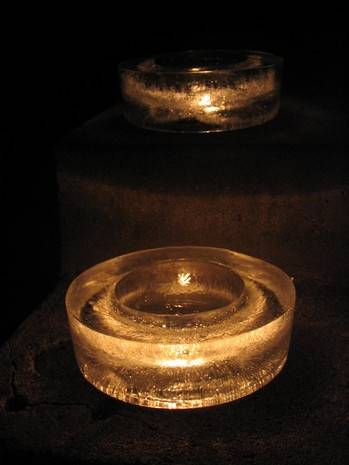 Light glows from a candle in the dark.