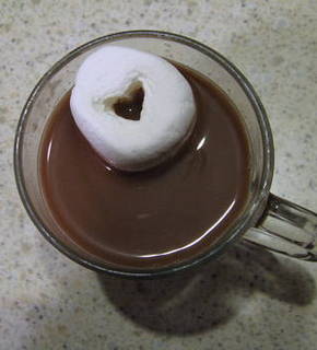 Heart shaped white marshmallow in a coffee cup for Valentine.