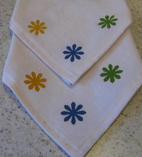 Floral stencil art on white color napkins.
