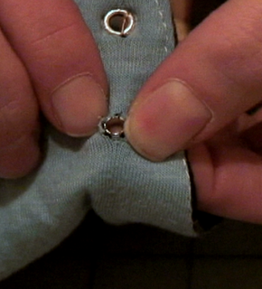 A corset hole being made