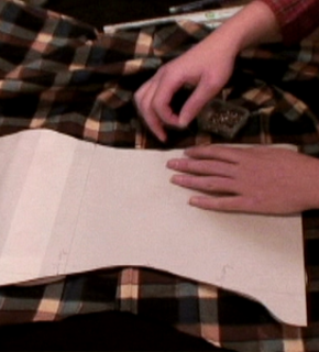 A woman sewing two pieces of fabric together.